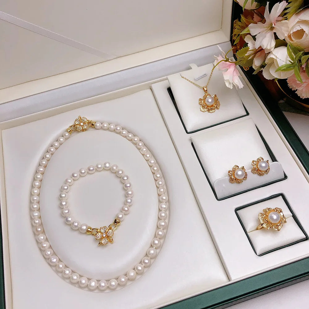 Jewelry set with purple and black freshwater pearls displayed in gift box