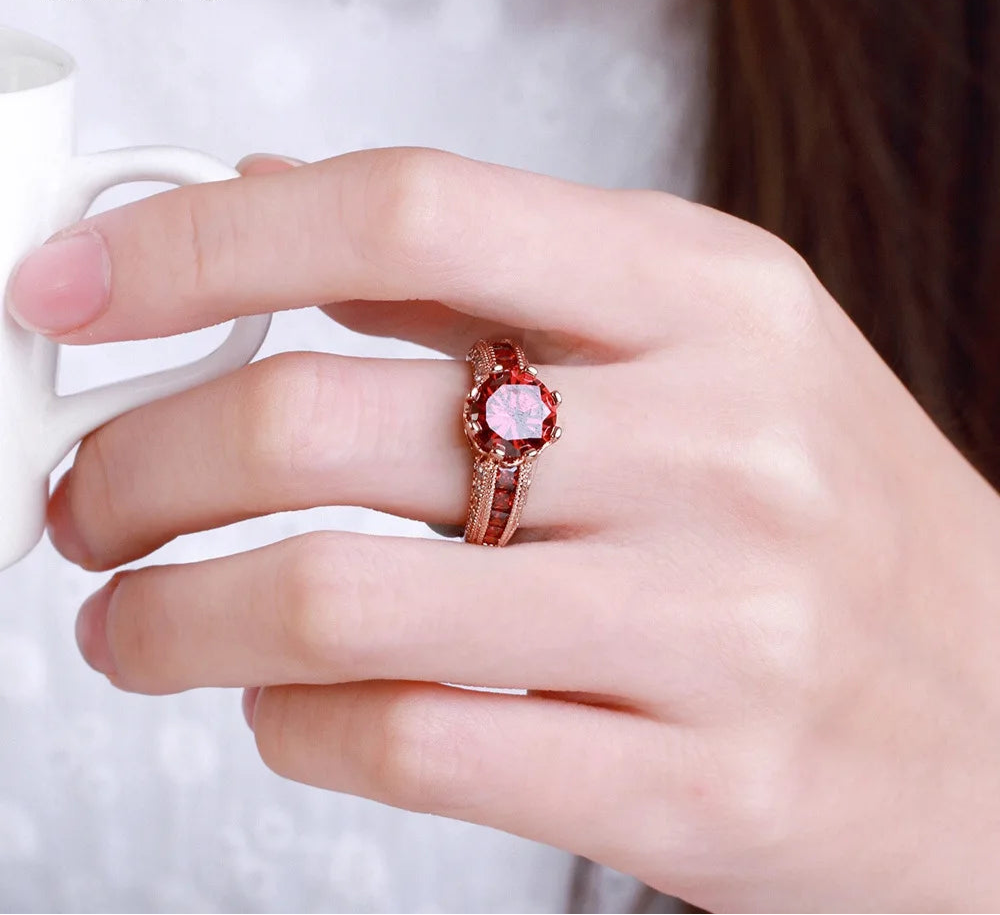 Side view of ruby engagement ring with yellow gold band