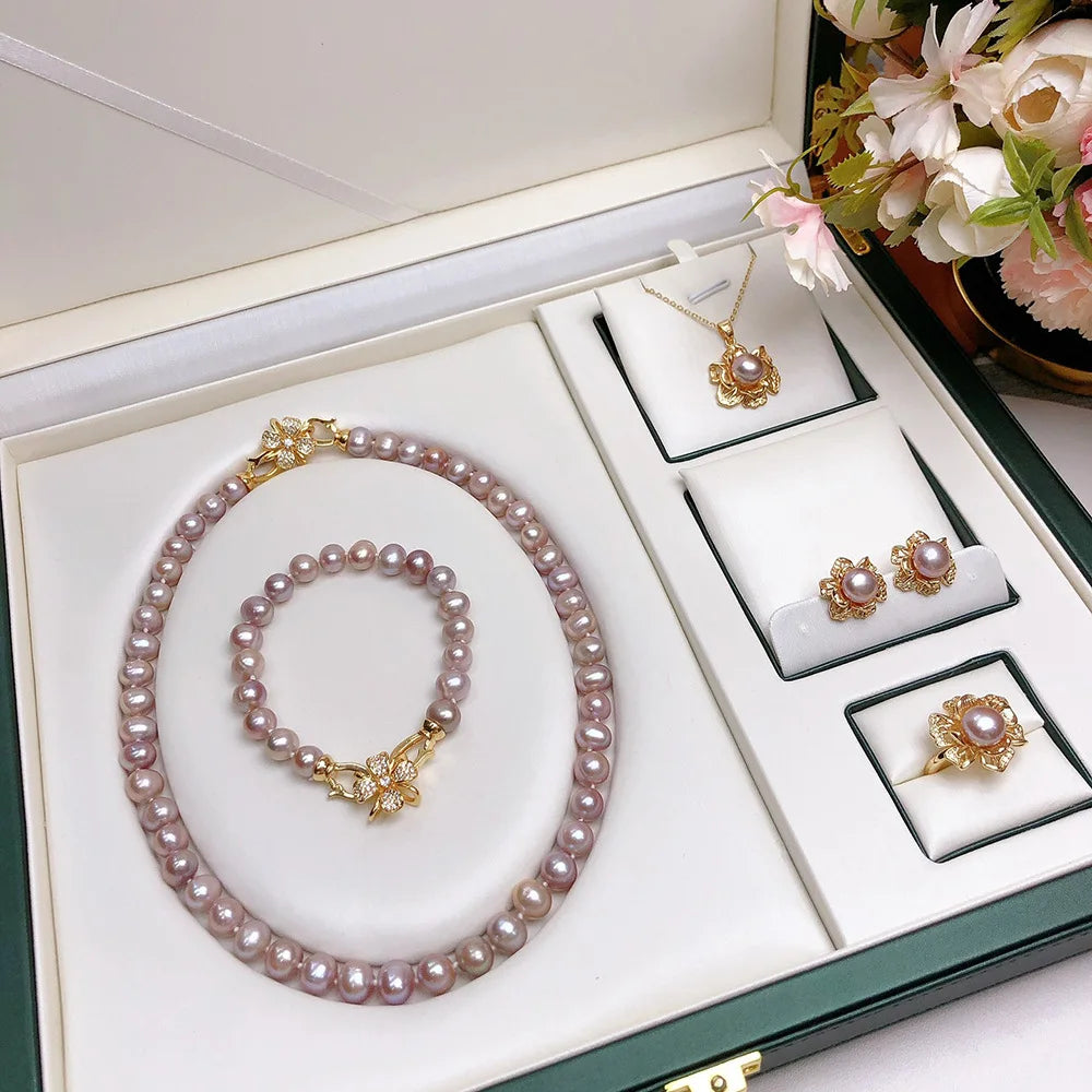 Close-up of pink freshwater pearl earrings with matching necklace and bracelet