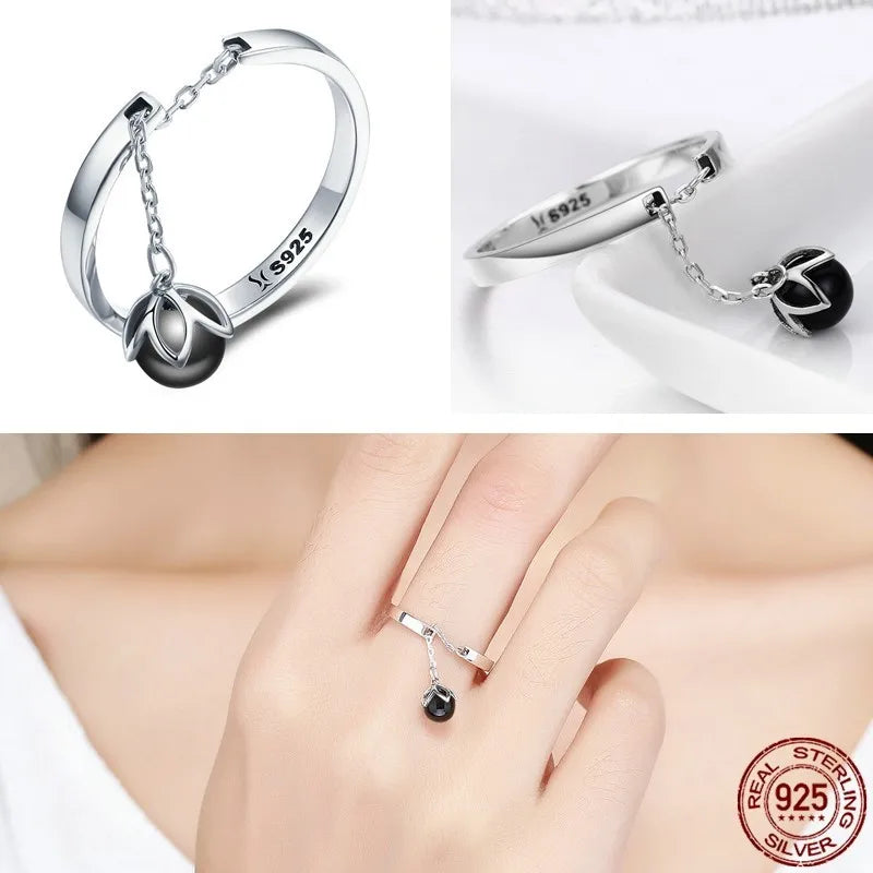 Woman wearing silver pearl ring on finger