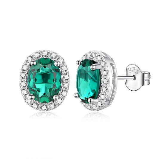 Close-up of 1.5CT lab emerald and moissanite diamond earrings

