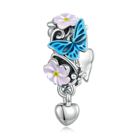 Sterling silver charm with white daisy, blue butterfly, and hanging heart

