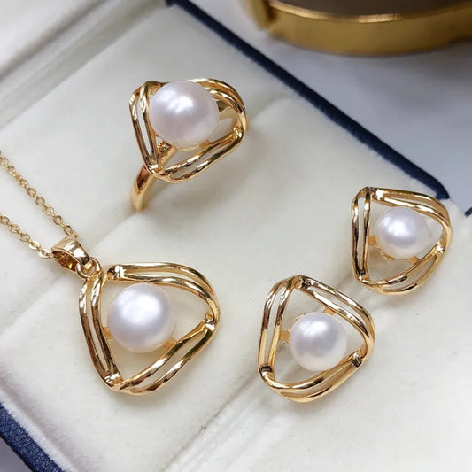 Close-up of freshwater pearl jewelry set with golden wire flower design

