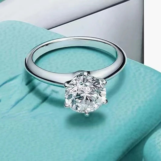 Close up view of 2 carat moissanite diamond ring in sterling silver
