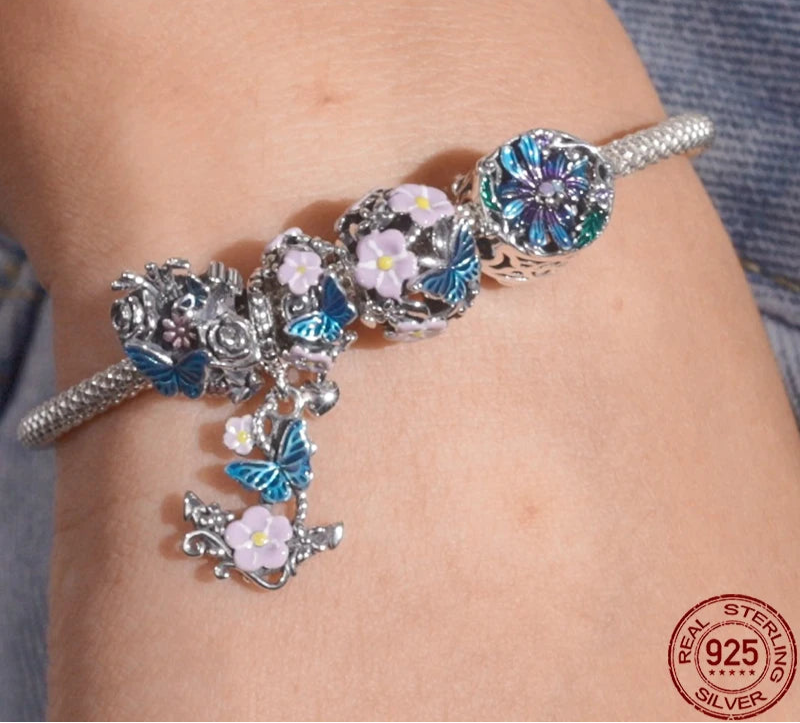 Sterling silver cross charm with butterfly and flower design

